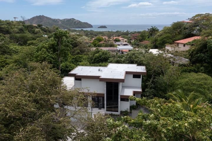 The house in the trees with the bay of Playas del Coco beyond