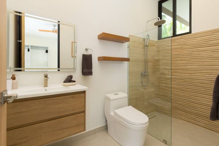 Bathroom with walk-in rain shower and oak vanity