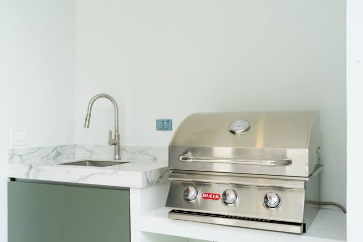 Built-in gas grill and sink on the pool terrace